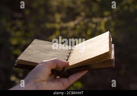 Opened old book with reflected in black surface. Stock Photo