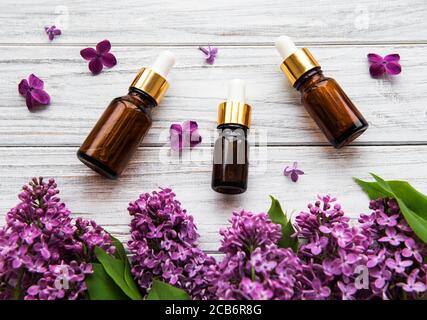 Essential oil of lilac flowers in glass bottles Stock Photo