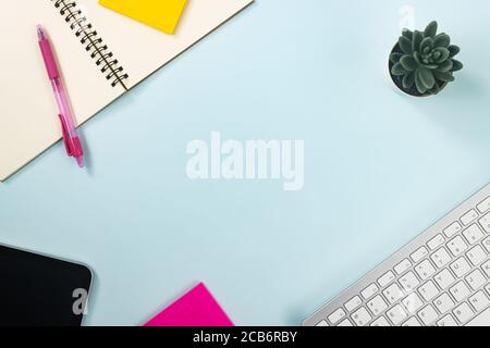 Minimalist Background and Spiral Notebook or Spring Notebook with Stationery such as Pen and Color Sticky Note and Computer Keyboard and Tablet and Tr Stock Photo