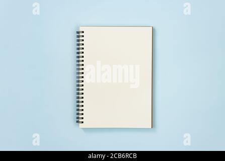 Spiral Notebook or Spring Notebook in Unlined Type on Blue Pastel Minimalist Background Stock Photo