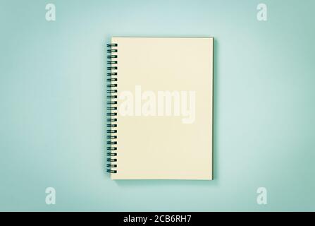 Spiral Notebook or Spring Notebook in Unlined Type on Blue Pastel Minimalist Background in Vintage Tone Stock Photo