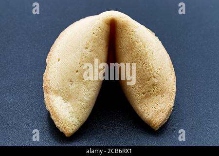 Chinese fortune cookie isolated on dark background Stock Photo