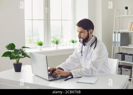 Young male doctor giving online consultation to his client online at clinic. Therapist talking to patient on web Stock Photo