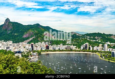 View of Botafogo district coastline with Guanabara bay waters full of  sailboats and vessels anchored nearby the Yatch Club under summer sunny day  Stock Photo - Alamy