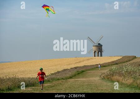Jack, 10, plays with his kite as he enjoys the hot weather by Chesterton Windmill, Warwickshire. Stock Photo