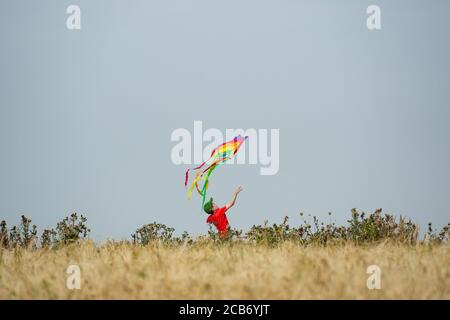 Jack, 10, plays with his kite as he enjoys the hot weather by Chesterton Windmill, Warwickshire. Stock Photo