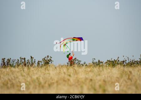 Jack, 10, plays with his kite as he enjoys the hot weather by Chesterton Windmill, Warwickshire. Stock Photo