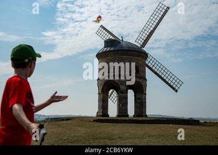 Jack, 10, plays with his kite as he enjoys the hot weather by Chesterton Windmill, Warwickshire. Stock Photo