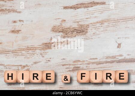 hire and fire printed on wooden cubes Stock Photo
