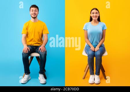 Studio shot of young couple sitting on the chairs Stock Photo