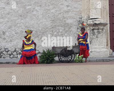 Local columbian women with traditional clothes at city square. Cartagena / Colombia. Stock Photo