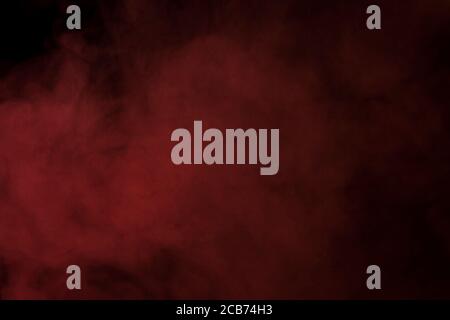 cloud of dense red vapor from an electronic cigarette concept of smoking and bad habits Stock Photo