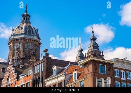 Low angle shot of traditional Amsterdam architecture under a cloudy sky in the Netherlands Stock Photo