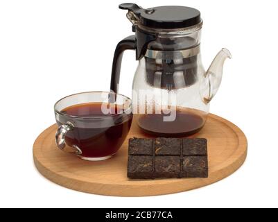 The cup of the chinese pu-erh tea, teapot on wooden board Stock Photo