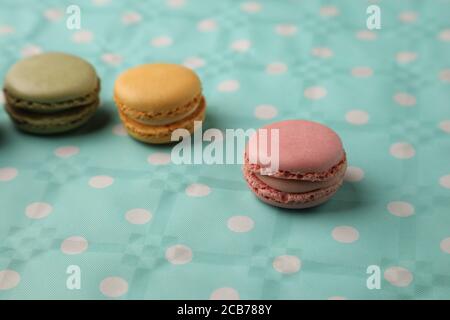 Closeup of a bunch of colorful macarons on a dotted surface Stock Photo