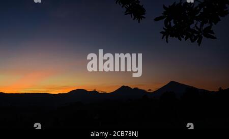 Beautiful view of the sky as the sun rises behind the mountain Stock Photo