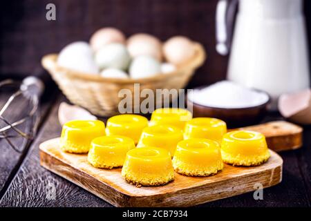 Brazilian quindim is a sweet made from egg yolk, sugar and grated coconut. Corresponds to the Portuguese recipe known as brisa-do-Lis, using grated co Stock Photo