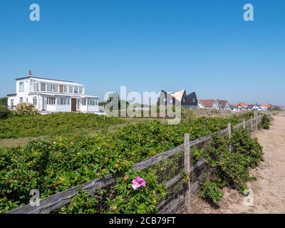 Houses and homes on the beach at Thorpness Suffolk UK Stock Photo