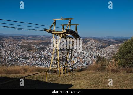 Cable car tower on the top of Do Cristo hill  with the city buildings in the background. Stock Photo