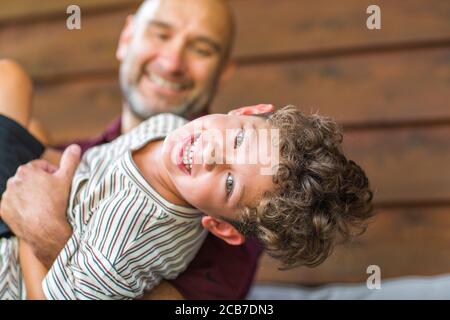 Hispanic father sitting and hugging his son. Stock Photo