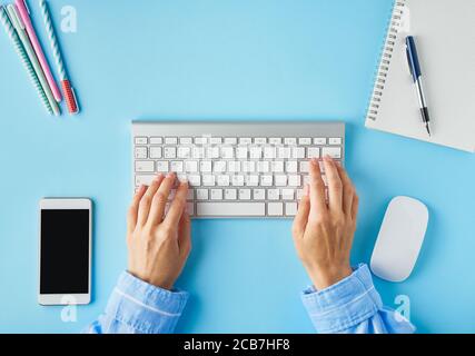 Bright blue modern desk. Top view. Distance education. Copy space, mock up. Stock Photo