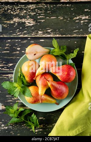 Top view of ripe and juicy pears on dark rustic wooden background Stock Photo