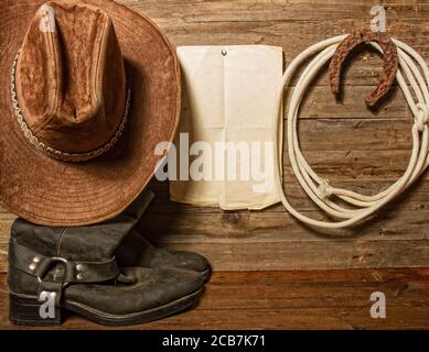 Vintage cowboy boots, hat and rope on an old handmade bench on an old ranch  in New Jersey, USA, farm Stock Photo - Alamy