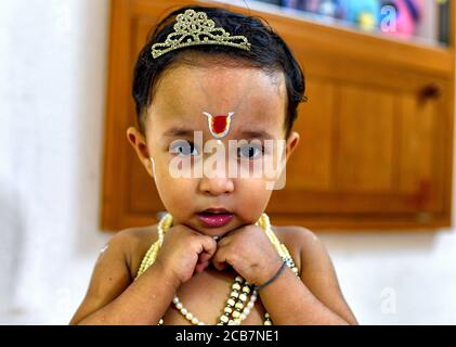 Kolkata, India. 11th Aug, 2020. A little kid dressed up as Lord Krishna during the Janmashtami Festival as per traditional ritual.Due to Covid 19 Temples are restricted for Public access this year and devotees are celebrating the Ritual at home. Krishna Janmashtami is an annual Hindu festival that celebrates the birth of Krishna, the eighth avatar of Vishnu. Credit: Avishek Das/SOPA Images/ZUMA Wire/Alamy Live News Stock Photo