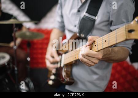 Cropped male guitarist playing his electric guitar Stock Photo