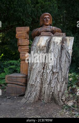 Sculptures of Bishops in and around trees carved by Andrew Frost in the grounds of  Fulham Palace, West London UK Stock Photo