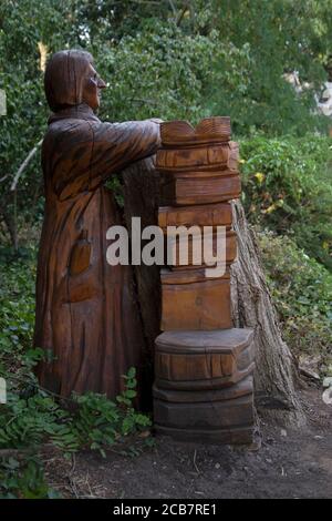 Sculptures of Bishops in and around trees carved by Andrew Frost in the grounds of  Fulham Palace, West London UK Stock Photo