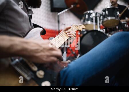 Close-up view of cropped man playing guitar Stock Photo