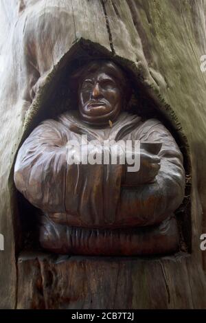 Sculptures of Bishops in and around trees carved by Andrew Frost in the grounds of  Fulham Palace, West London UK Stock Photo