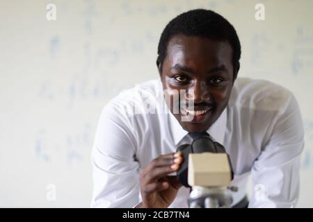 African scientist teacher looking microscopes in the laboratory Stock Photo