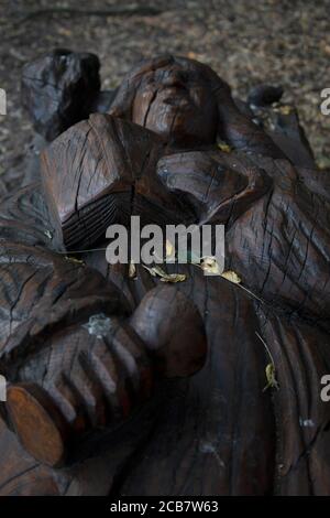 Sculptures of Bishops in and around trees carved by Andrew Frost in the grounds of  Fulham Palace, West London UK Stock Photo