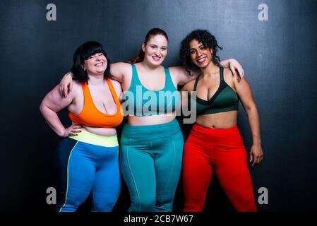 Plus size women making sport and fitness. Studio portraits with