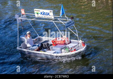 Canow, Germany. 06th Aug, 2020. Jens Winkelmann is on the move with his water kiosk on the Müritz-Havel Canal and supplies holidaymakers on houseboats, yachts and canoes with ice, cold drinks or freshly smoked fish. Every day during the season he is on the waterways and lake at the state border of Brandenburg and Mecklenburg for up to 80 kilometres. The Brandenburg native has converted his four-metre-long, old barge into a kind of 'floating consumption' with a freezer and and fresh-keeping boxes. Credit: Jens Büttner/dpa-Zentralbild/ZB/dpa/Alamy Live News Stock Photo