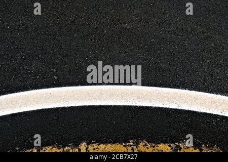 Wide curved reflective band at a roundabout, an abstract road detail. Stock Photo