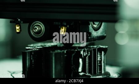 3D printer working in a factory printing plastic part. Stock Photo