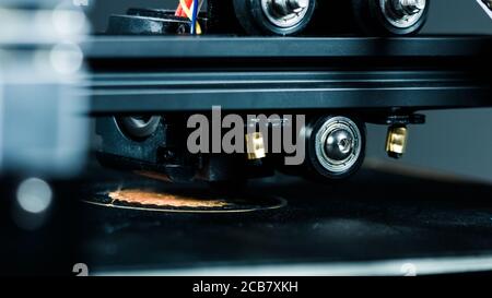 3D printer working in a factory printing plastic part. Stock Photo