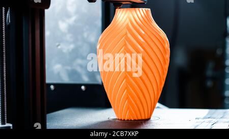 3D printer working in a factory printing plastic part. Stock Photo
