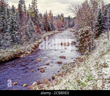 Early winter snow in fall colorful trees on the West Branch of the Ausable River in Lake Placid the Adirondack Mountains of New York State United St Stock Photo