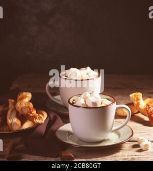 Hot chocolate with cinnamon and marshmallow on wooden background Stock Photo