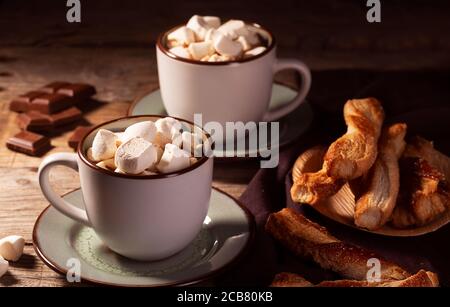 Hot chocolate with cinnamon and marshmallow on wooden background Stock Photo