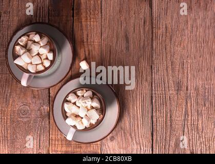 Hot chocolate with cinnamon and marshmallow on wooden background Stock Photo