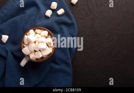 Hot chocolate with cinnamon and marshmallow on dark background Stock Photo