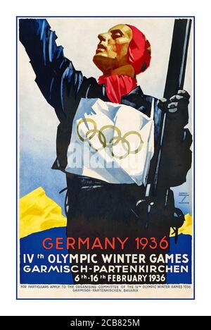 1936 vintage Winter Olympics sport poster in Danish: Tyskland 1936 (Nazi Germany / The Third Reich / Germany 1936) IV Winter Olympiade (Winter Olympics) Garmisch-Partenkirchen 6-16 February 1936. image depicting a skier with bib featuring the Olympic rings symbol, celebrating victory with mountain in background. Poster artwork by Ludwig Hohlwein (1874-1949). Published by the Reichsbahn Centrale for German Travel Agents  Berlin Germany Stock Photo