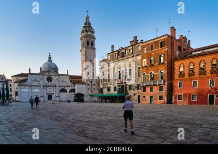 Three tourists walking through Campo Santa Maria Formosa in the, Venice, Veneto, Italy Stock Photo