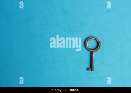 Key isolated on blue background Stock Photo