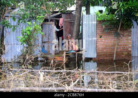 Villager sits in his house seen surrounded by the flood water in Savar near Dhaka, Bangladesh, on August 10, 2020 Stock Photo